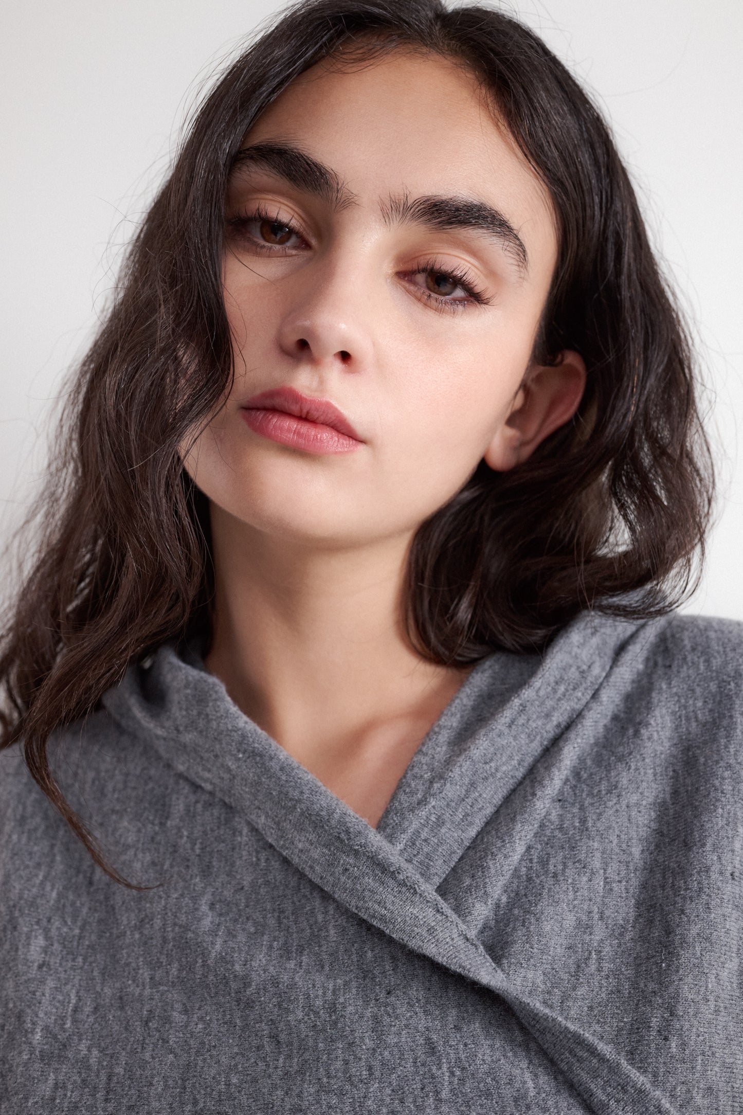 Crossover style hooded sweater